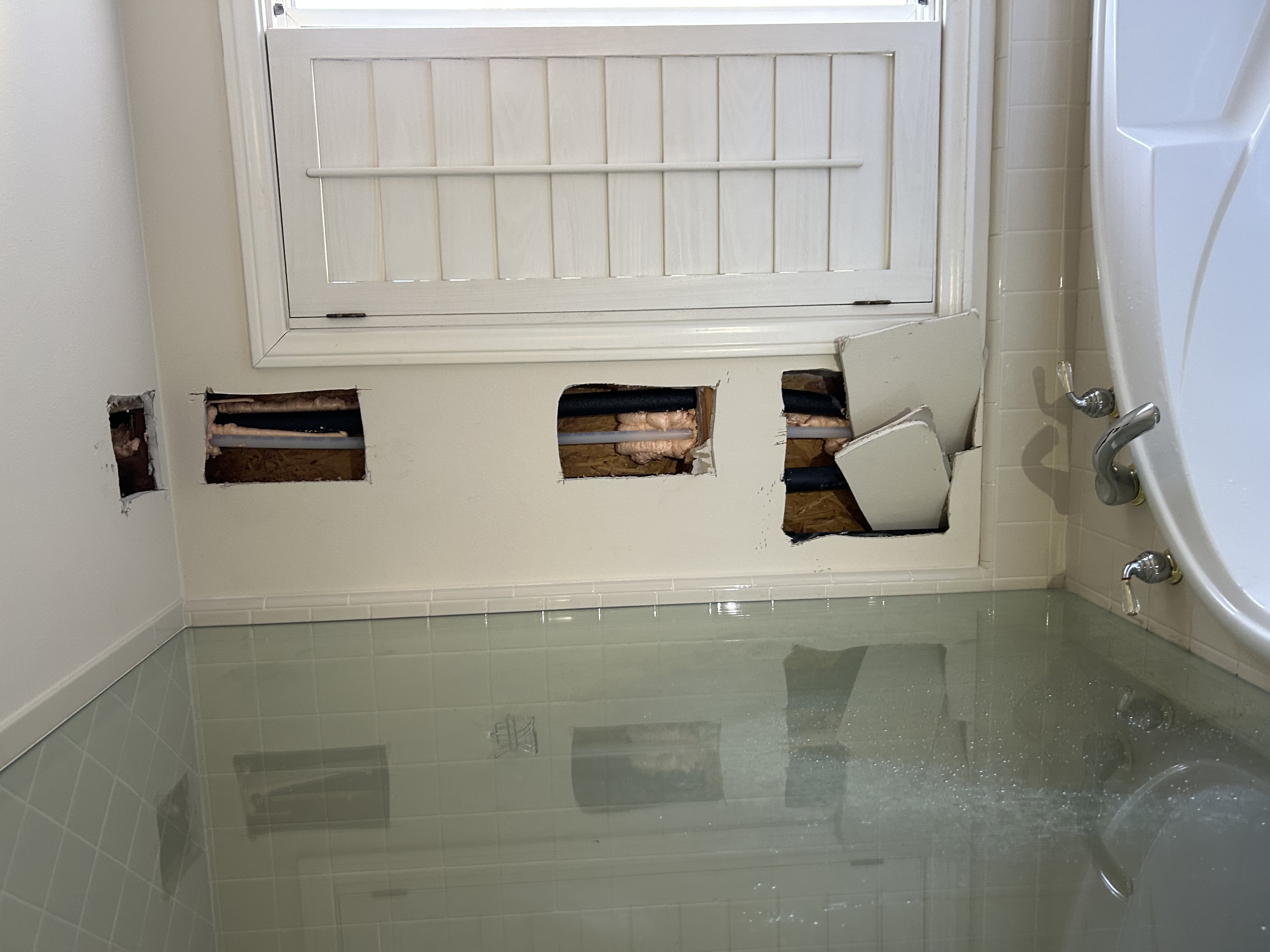 Interior wall with horizontal access cutouts during a PEX-A repipe