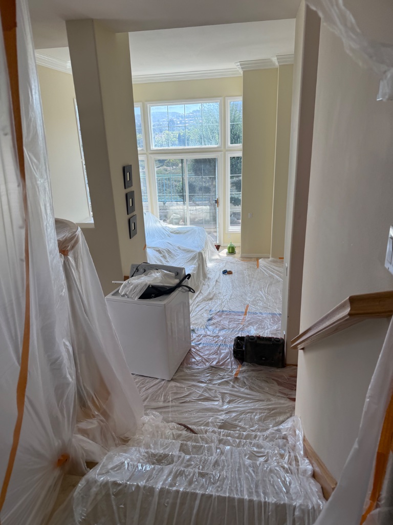 Home interior fully protected with plastic sheeting during whole-home repipe