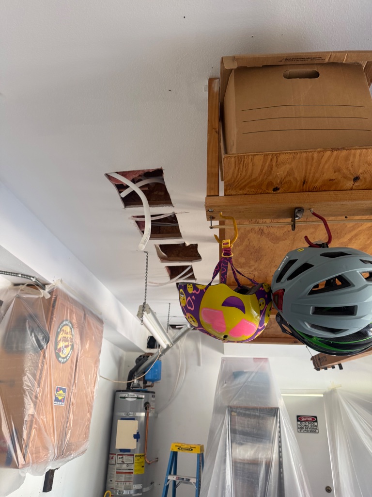 Garage ceiling access with water heater area and new pipe routing