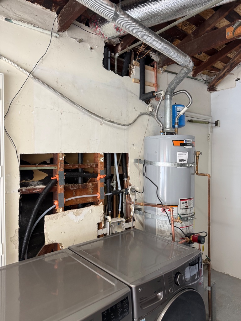 Garage laundry area with wall access and new copper mainline connections