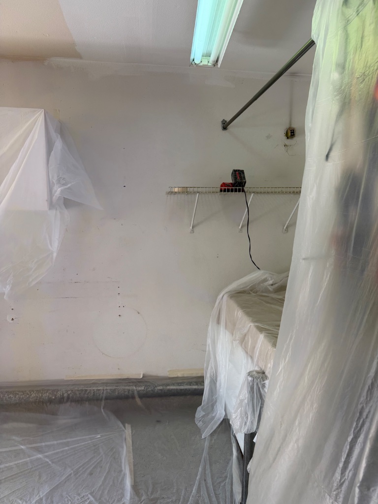Room corner sealed with plastic containment during whole-home repipe