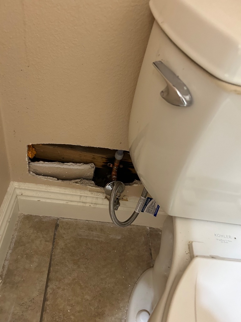 Bathroom baseboard access cut for new toilet supply line installation