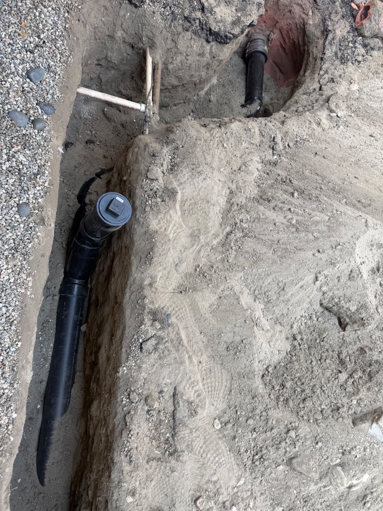 New ABS sewer line laid in trench — mainline replacement in progress