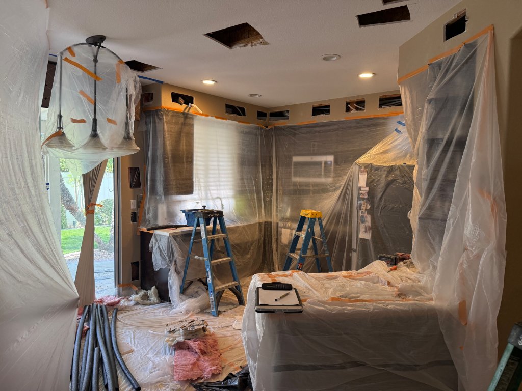 Living room fully protected — crew working overhead