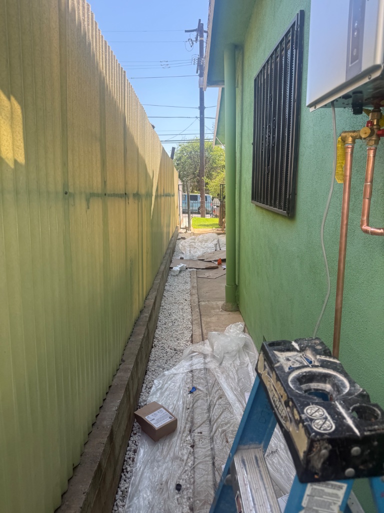 Exterior tankless water heater with new copper connections installed