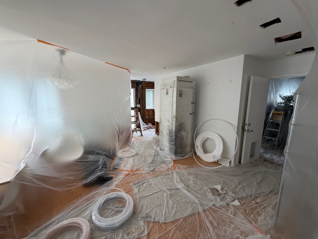 Home protection setup with plastic covering during whole-home repipe