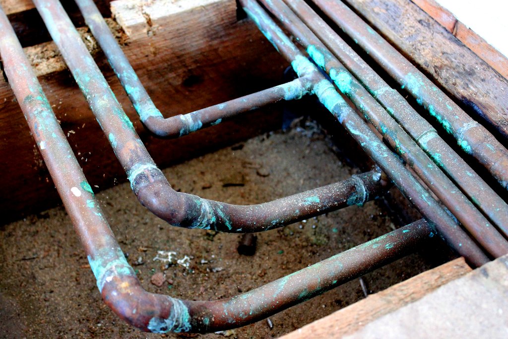 Old corroded copper pipes under a Southern California home