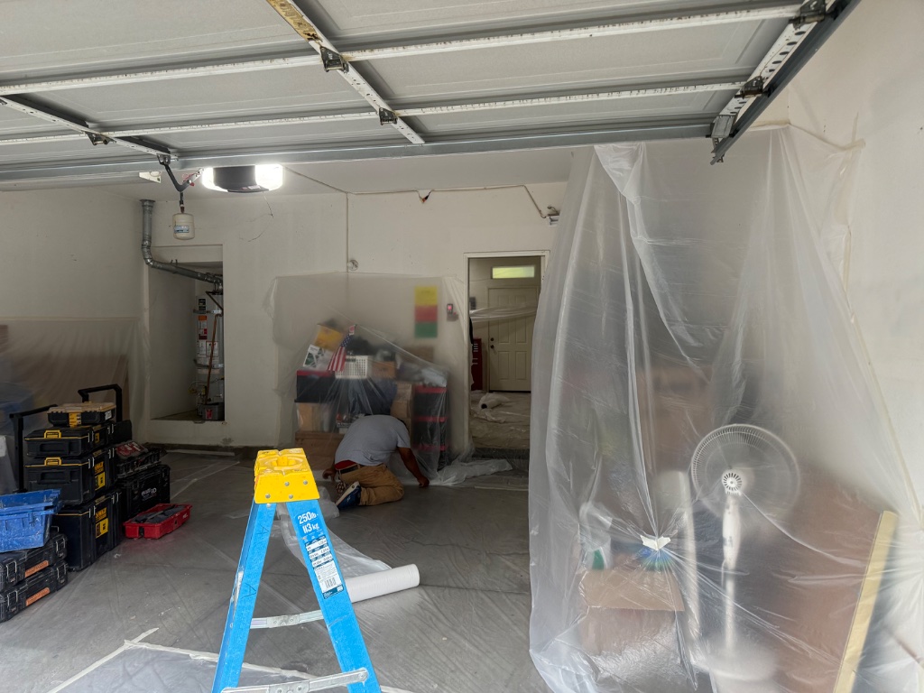 Garage staging area with crew at work and tools organized
