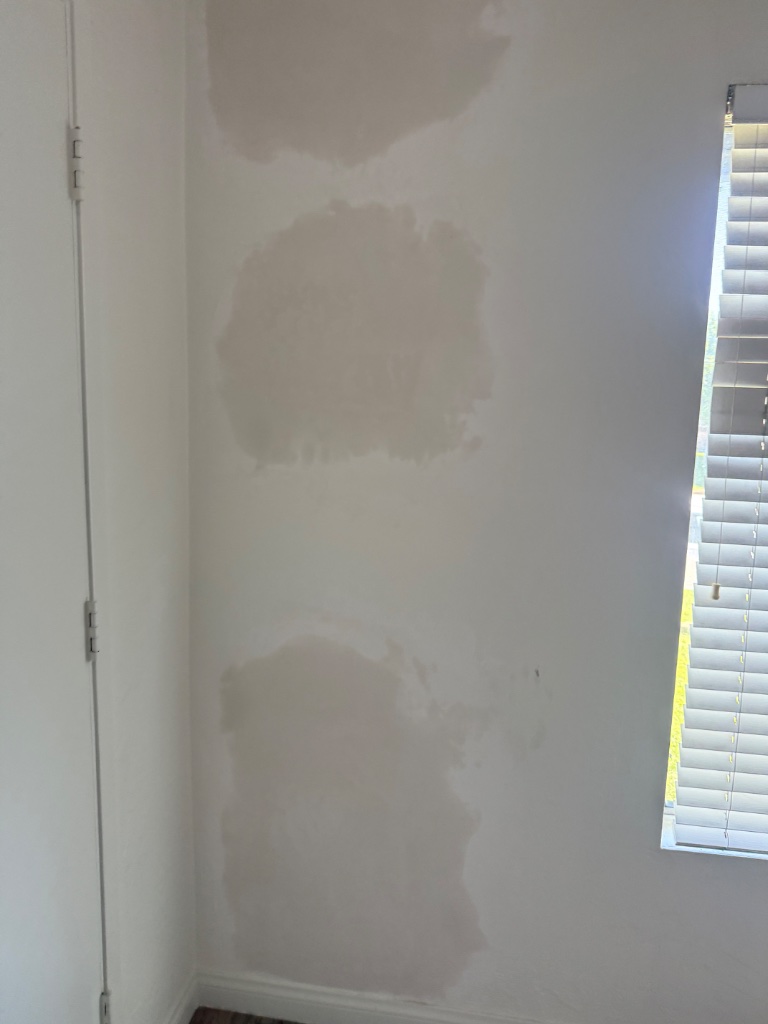 Drywall spackle patches applied in corner before final texture and paint