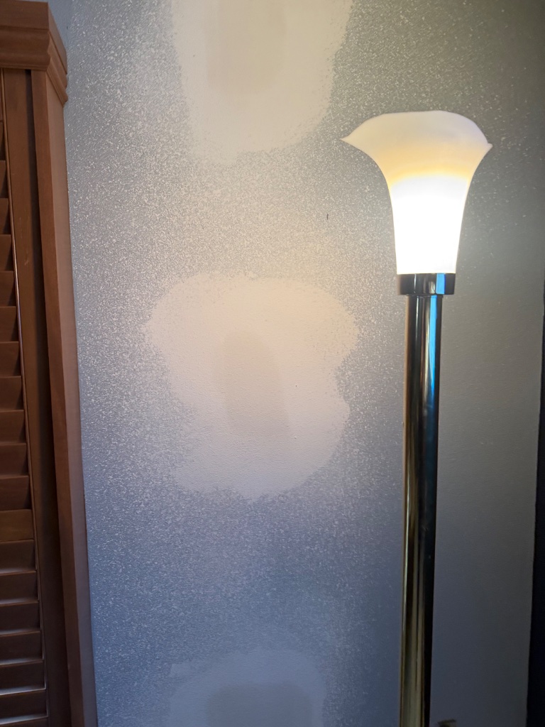 Wall texture repair in progress after repipe patching completed