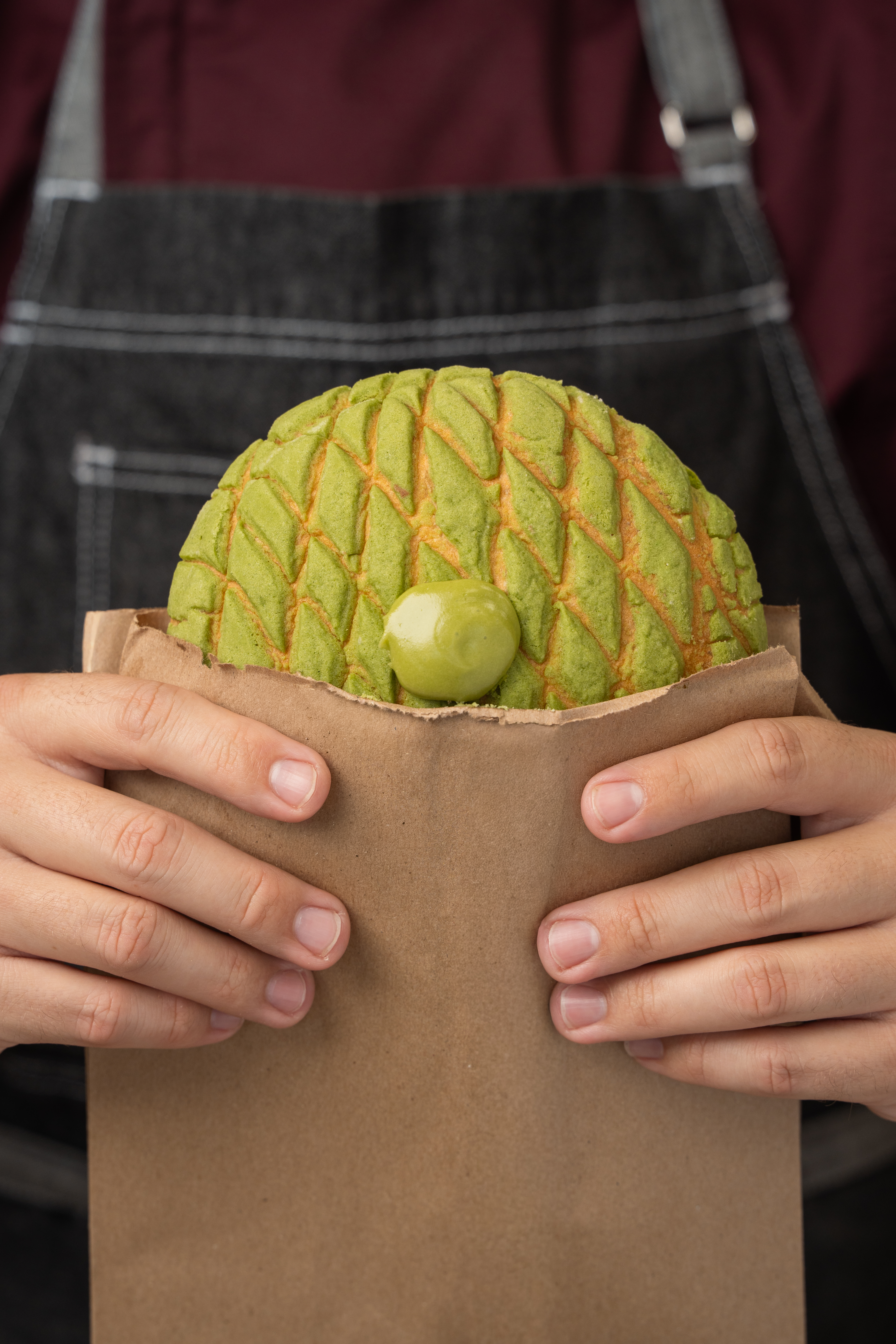 Matcha concha in a paper bag
