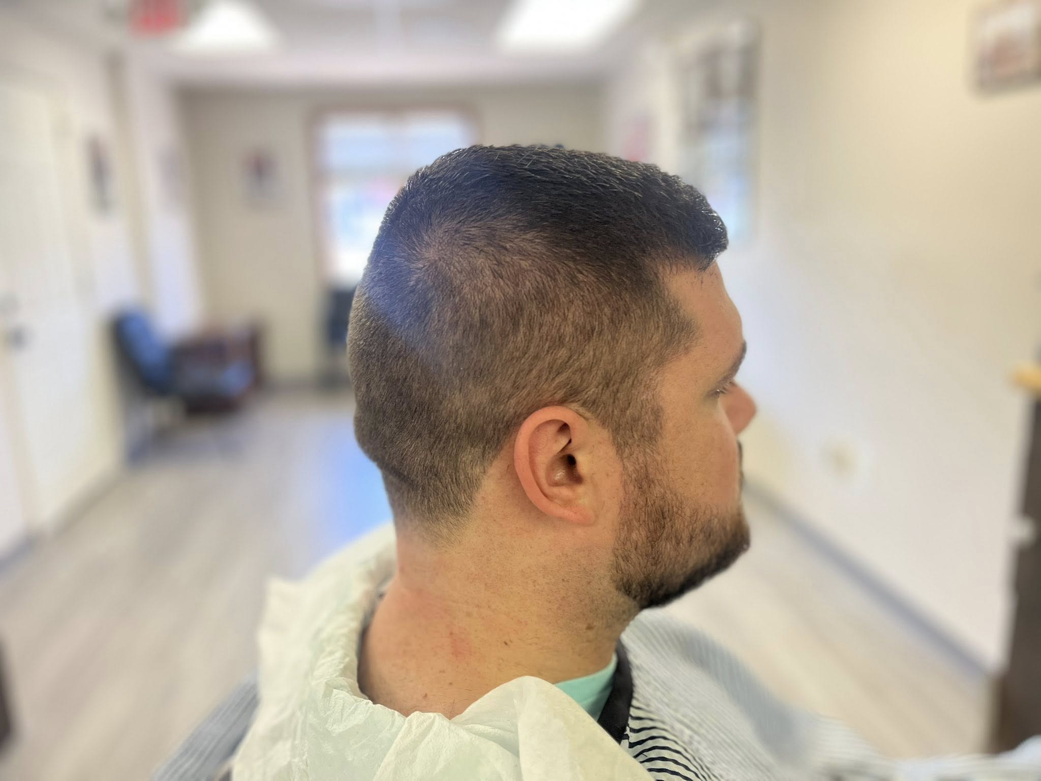 Master barber Paul performing a straight razor shave at Hairlines Flemington NJ