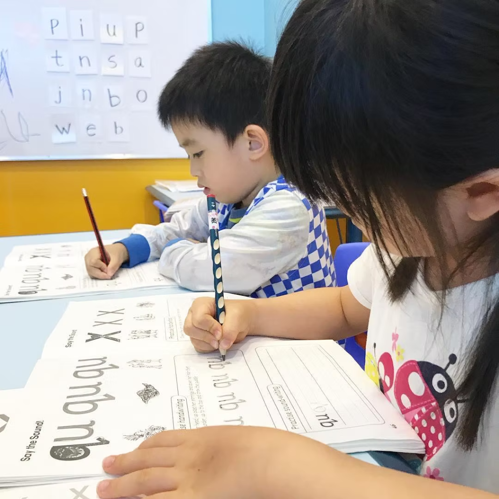 Children practising phonics writing