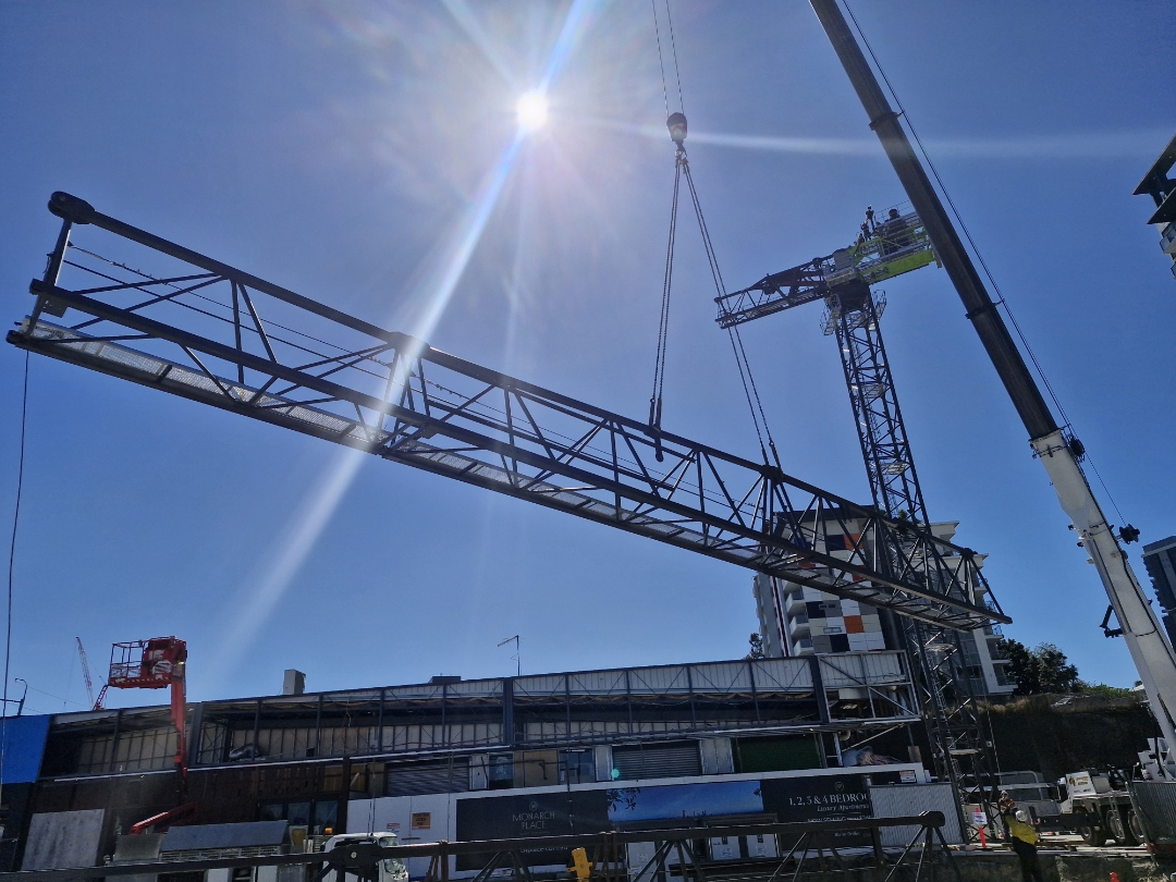 Crane jib section suspended above a Brisbane apartment construction site