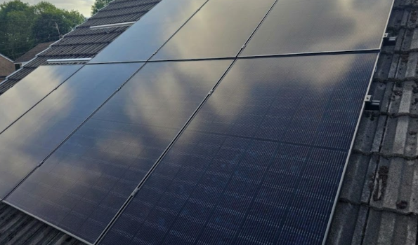 Modern UK home with solar panels installed on roof by Maybury Energy Services