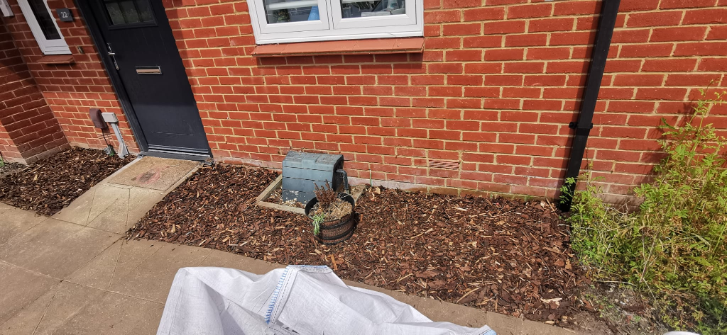 After: Front garden in Basingstoke cleared of weeds and finished with bark mulch and tidy shrub borders