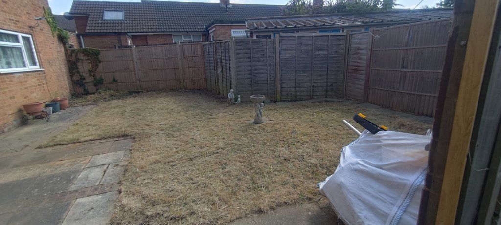 After: Overgrown rear garden in Basingstoke cleared of brambles and waste, leaving a level, tidy lawn area