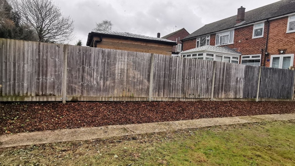 Cleared garden border with fresh bark mulch along fence line - Basingstoke garden tidy up