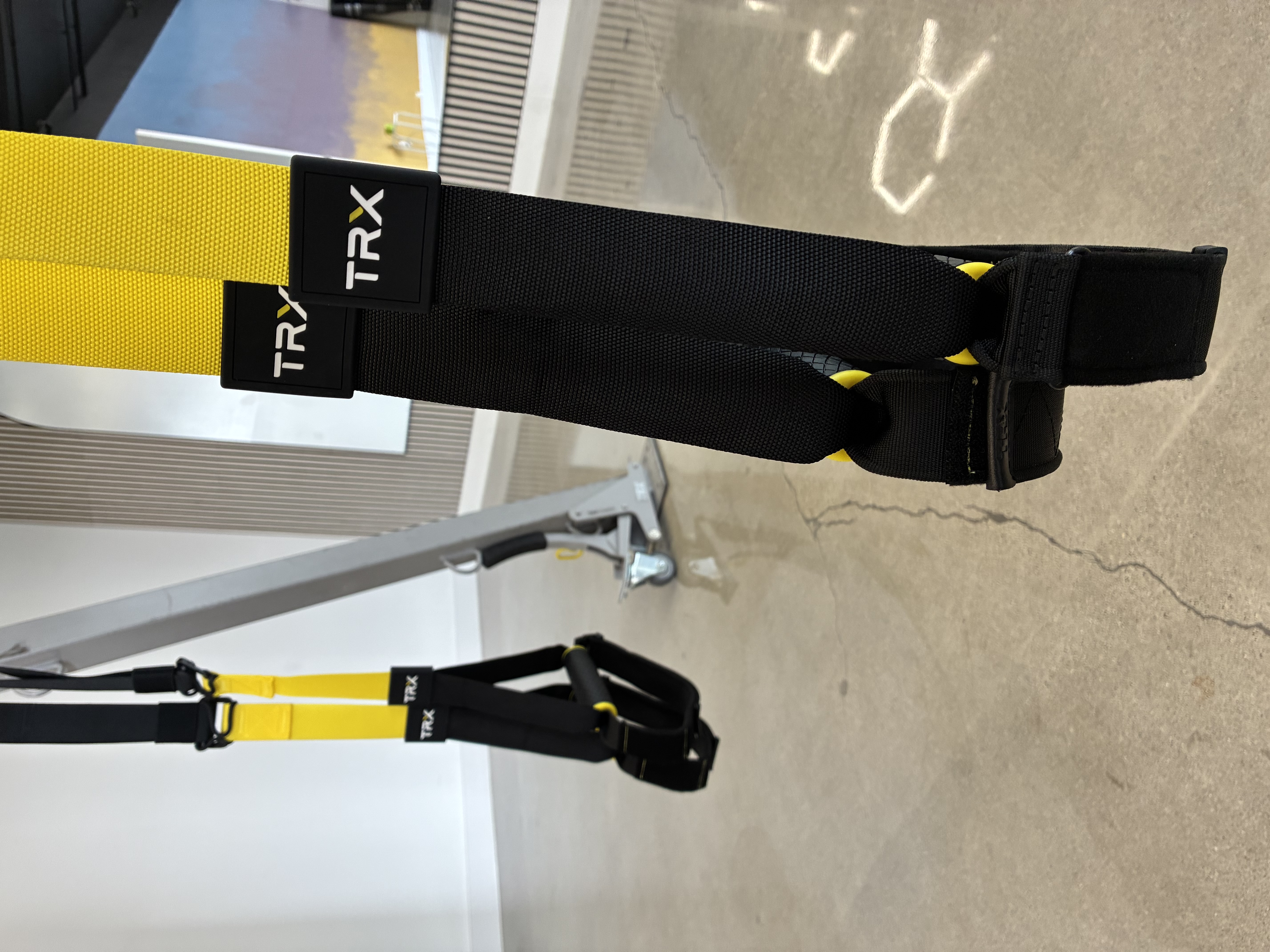 TRX suspension straps with yellow webbing in the Ventura studio