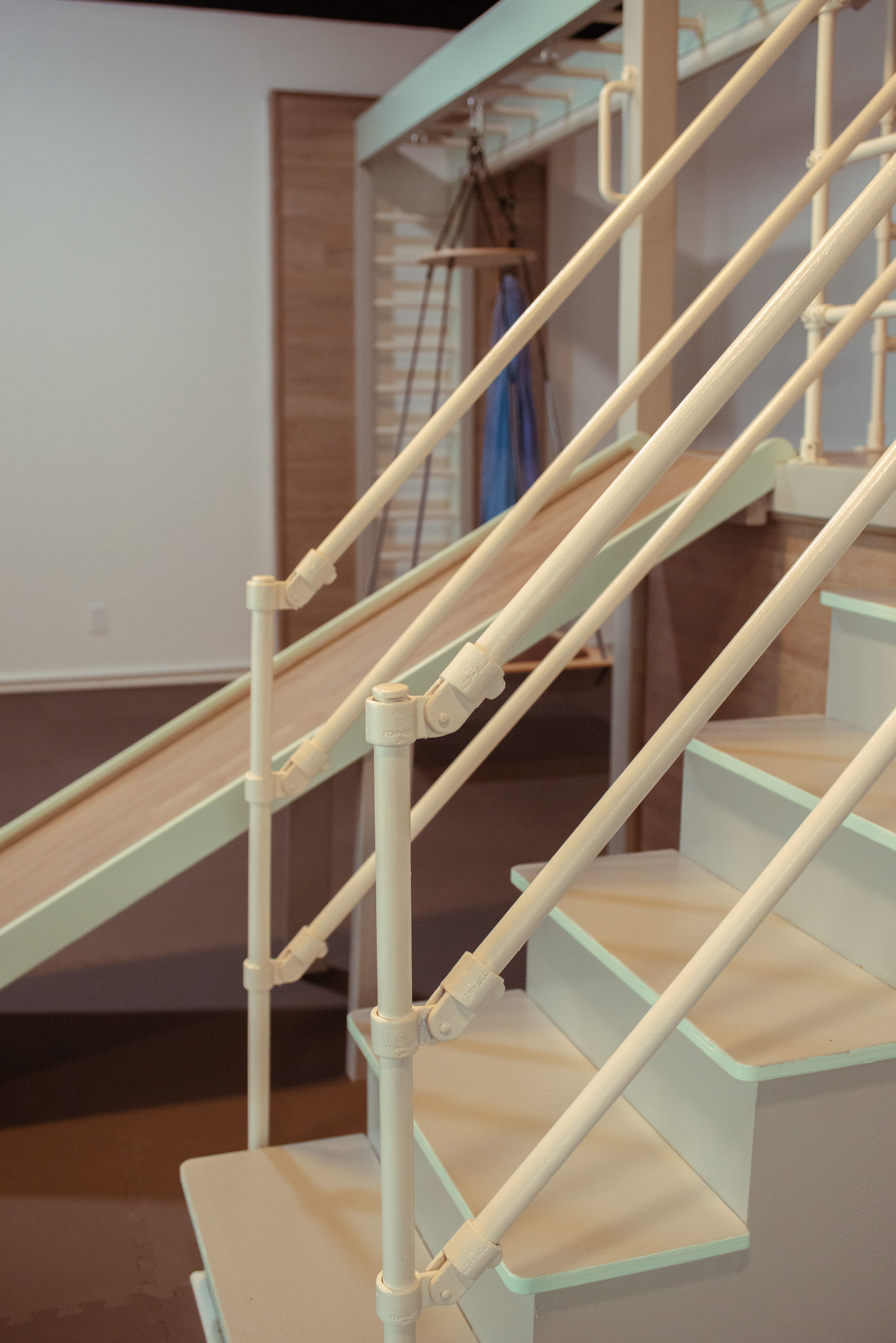Wooden stairs with a slide in the kids sensory gym