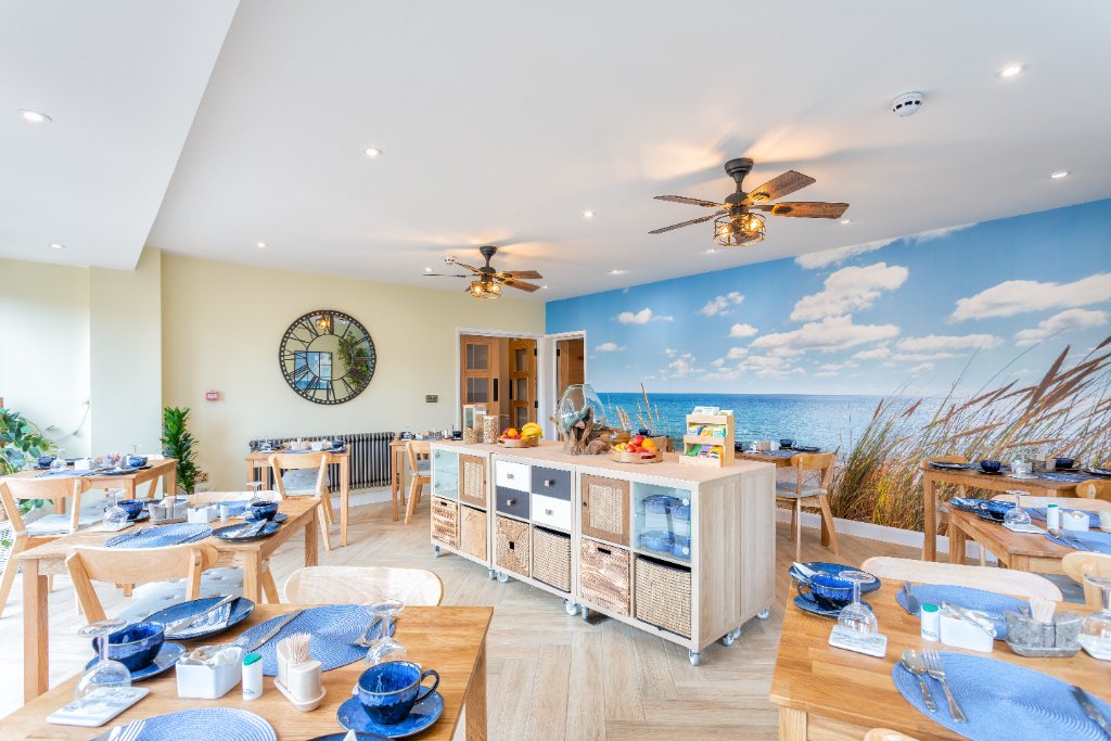 Breakfast dining room with coastal mural at Avoncourt Lodge