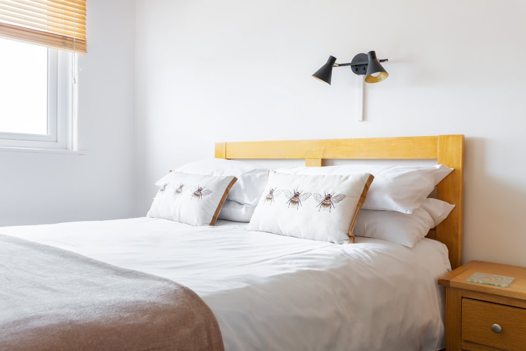 Double room with bee pillow detailing at Avoncourt Lodge