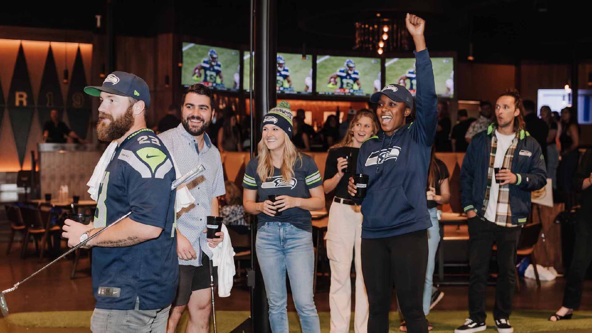 Seattle Seahawks fans watching football and putting at Putting World in Scottsdale