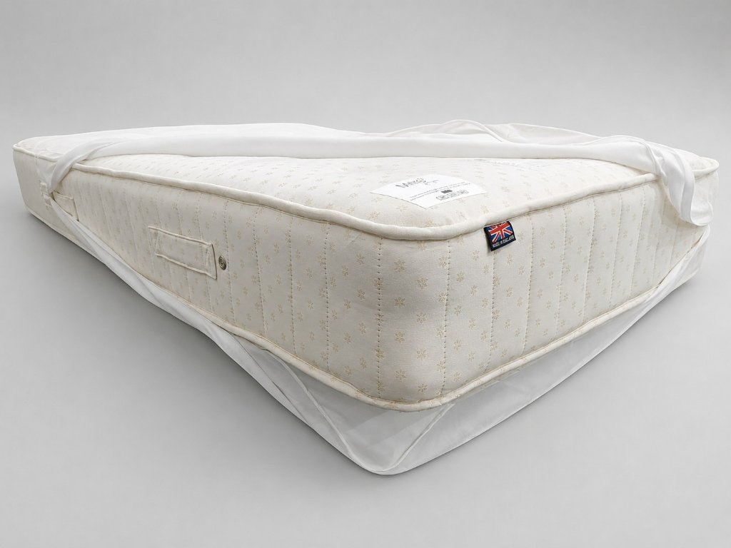 The mattress inside the same protector after eight years — immaculate condition, pristine ticking, Made in England label intact