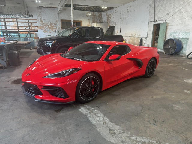 Red C8 Chevrolet Corvette Stingray in Capitol Glass shop