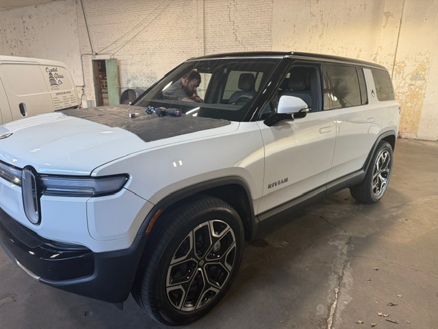 White Rivian R1S electric SUV windshield service at Capitol Glass