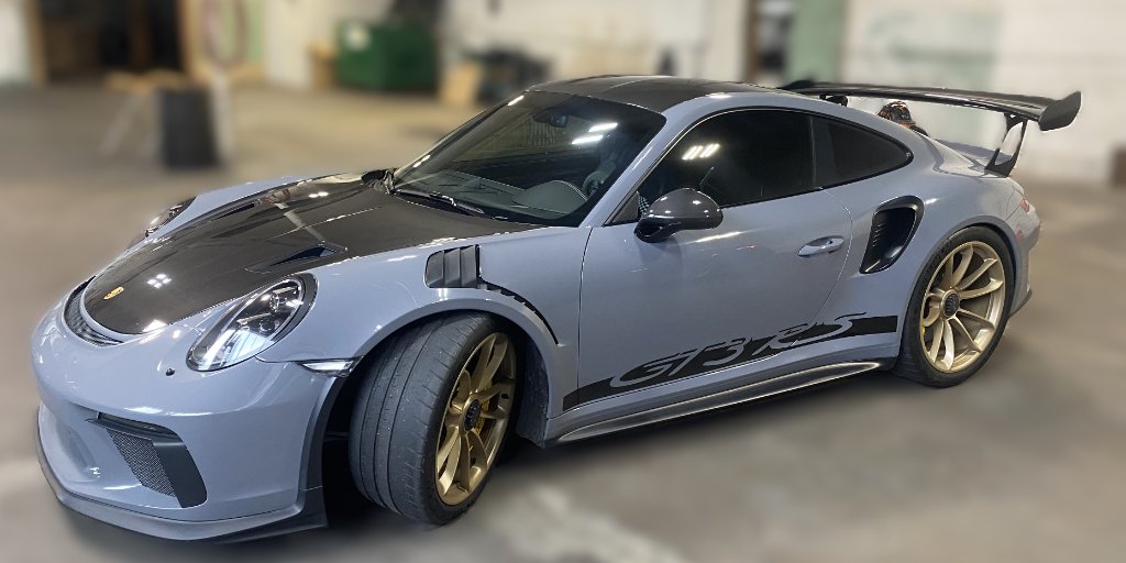 Gray Porsche 911 GT3 RS with gold wheels at Capitol Glass