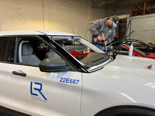 Technician replacing windshield on City of Little Rock fleet vehicle