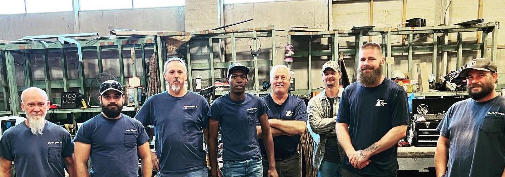 Capitol Glass Co. team of technicians standing in the auto glass repair shop in Little Rock