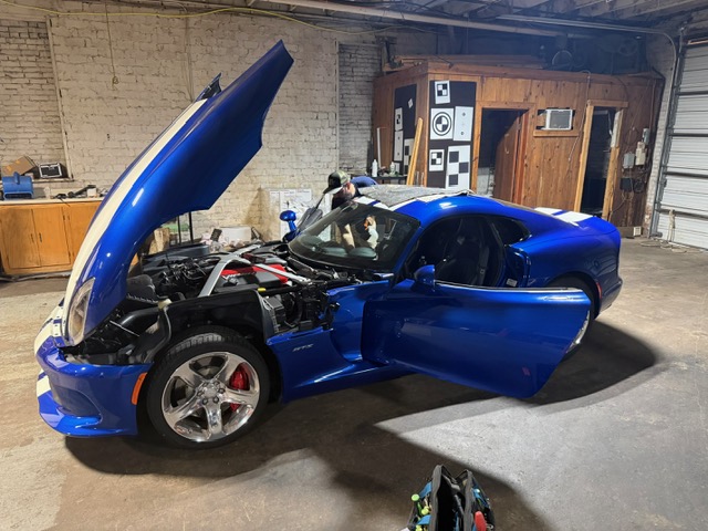 Blue Dodge Viper SRT with white stripes at Capitol Glass