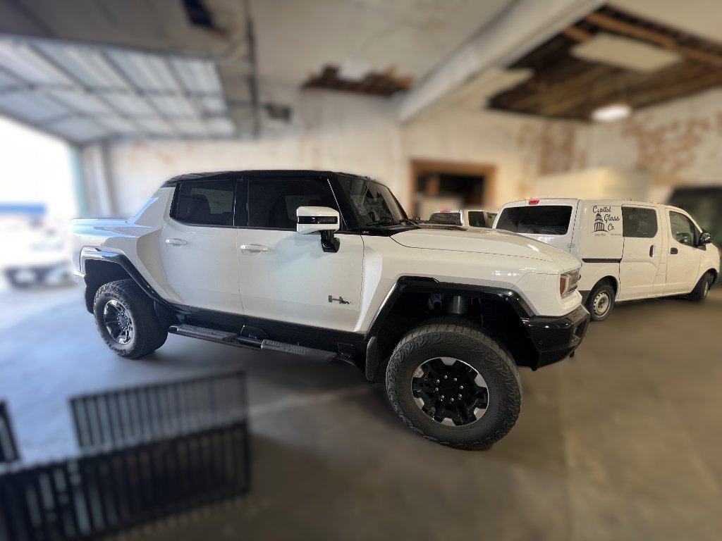White GMC Hummer EV pickup truck at Capitol Glass