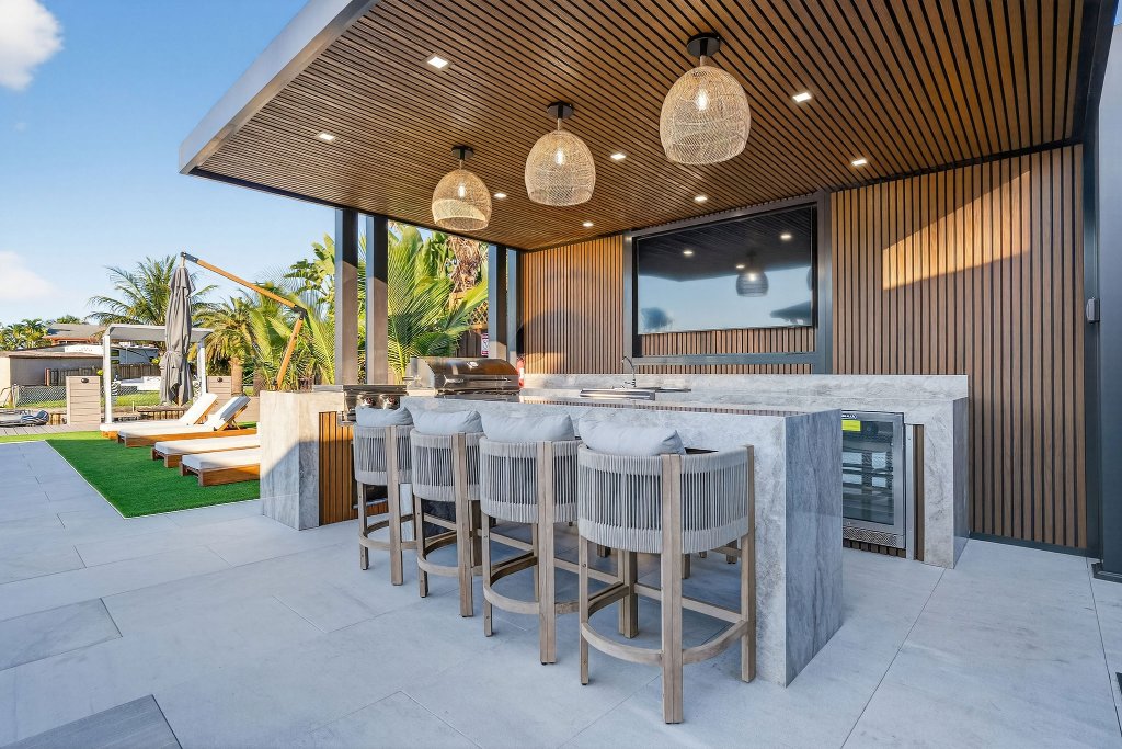 Outdoor kitchen with BBQ grill and waterfront dining