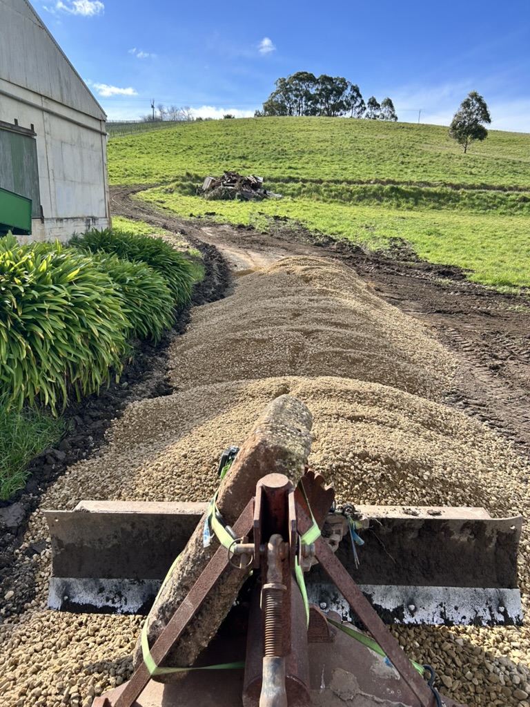 Levelling the gravel out front of the shed.