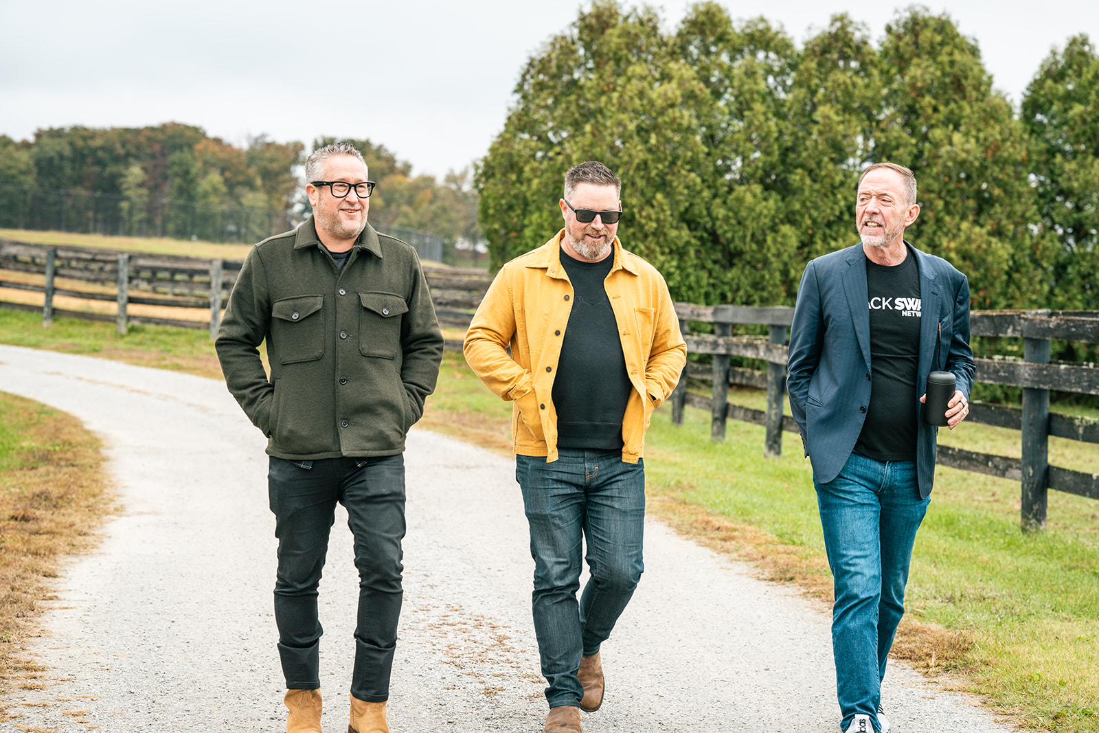 The three founders walking the farm road at the Founders Retreat