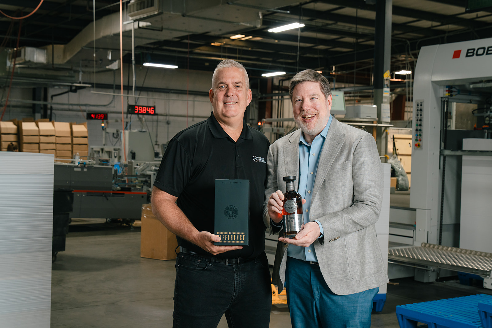 Mark Mills and James Kennedy on the factory floor at Spectrum Packaging in Orlando