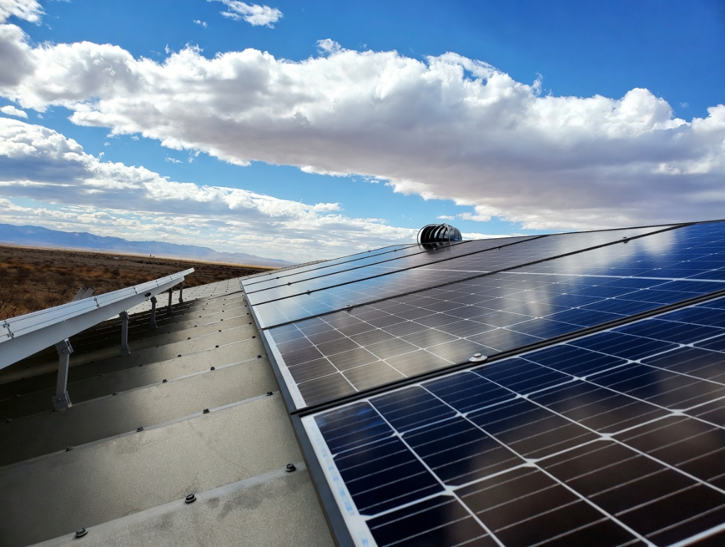 Solar panels on roof with desert mountains in background