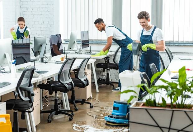 Group of people cleaning an office