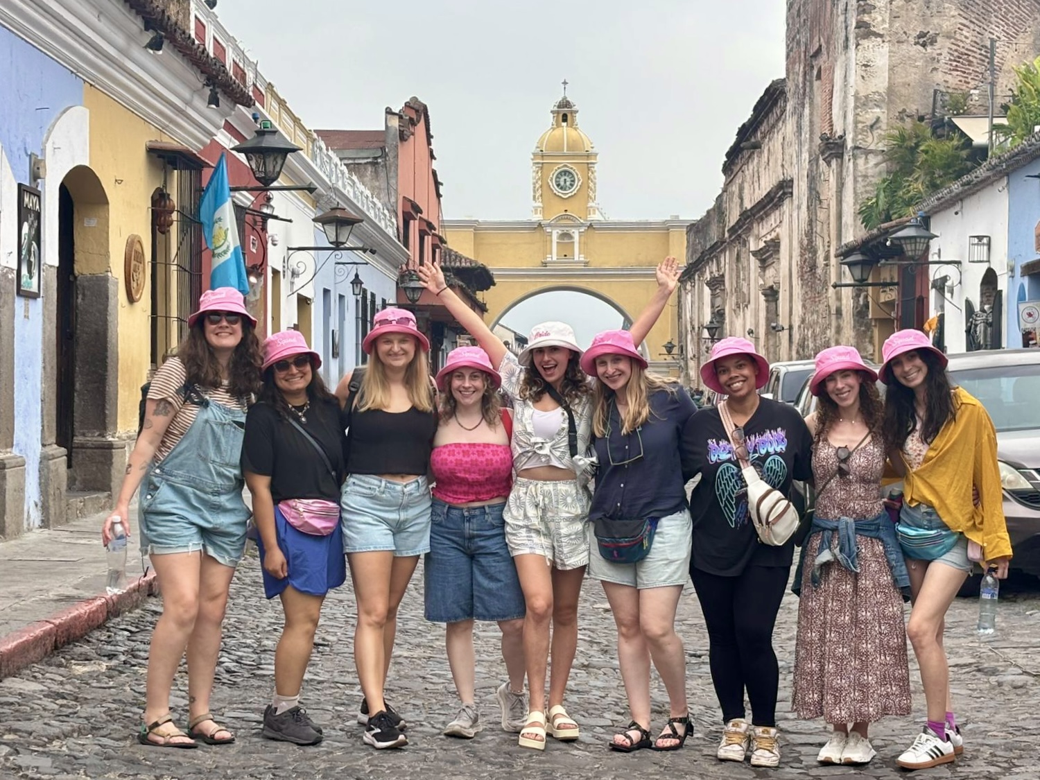 Tour group in pink bucket hats at Santa Catalina Arch