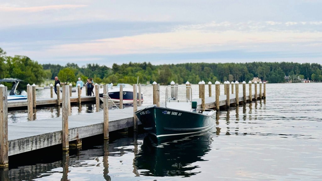 Boat docked at marina with calm lake waters
