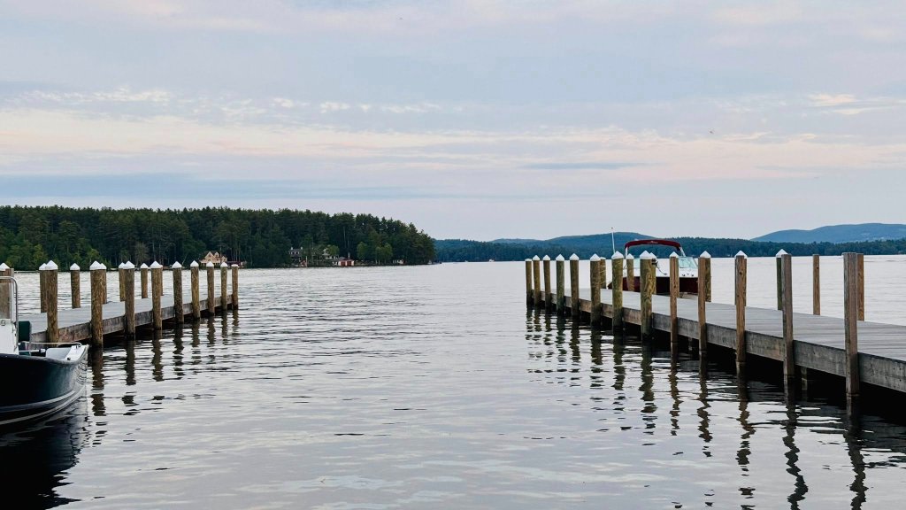 Twin docks stretching into calm lake at sunset