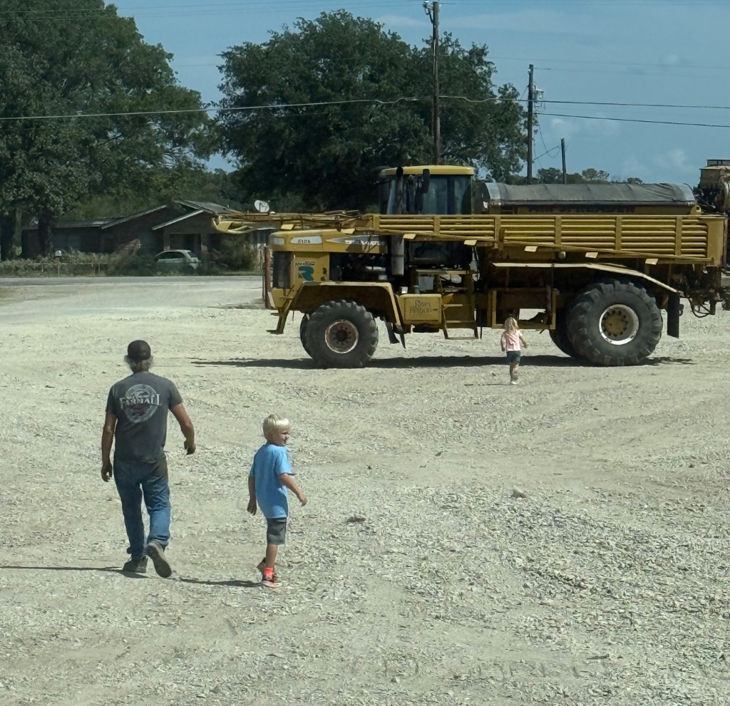 Kid waving from New Holland tractor