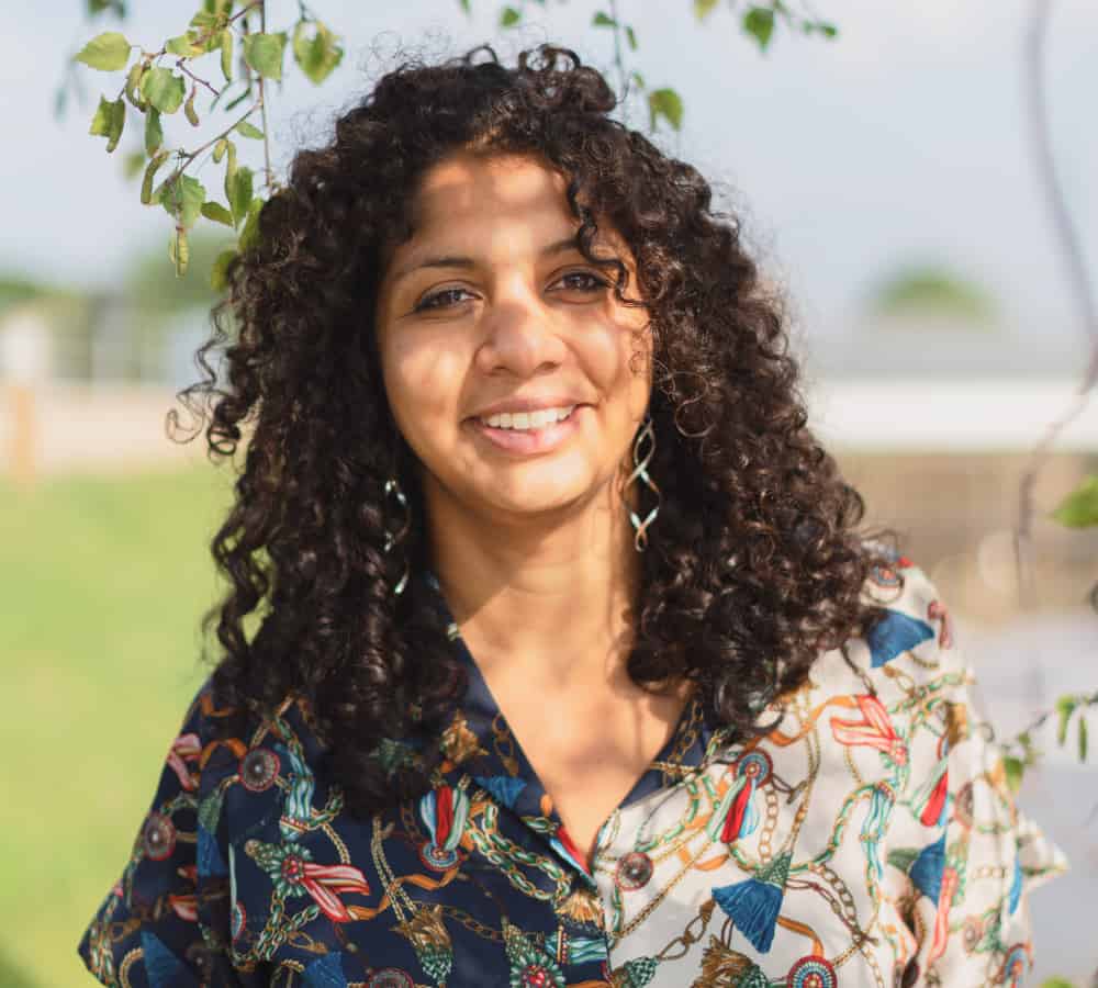 Woman with curly hair and floral top