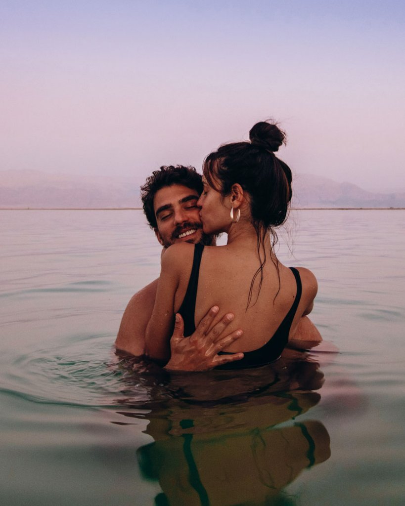 Couple in water at sunset
