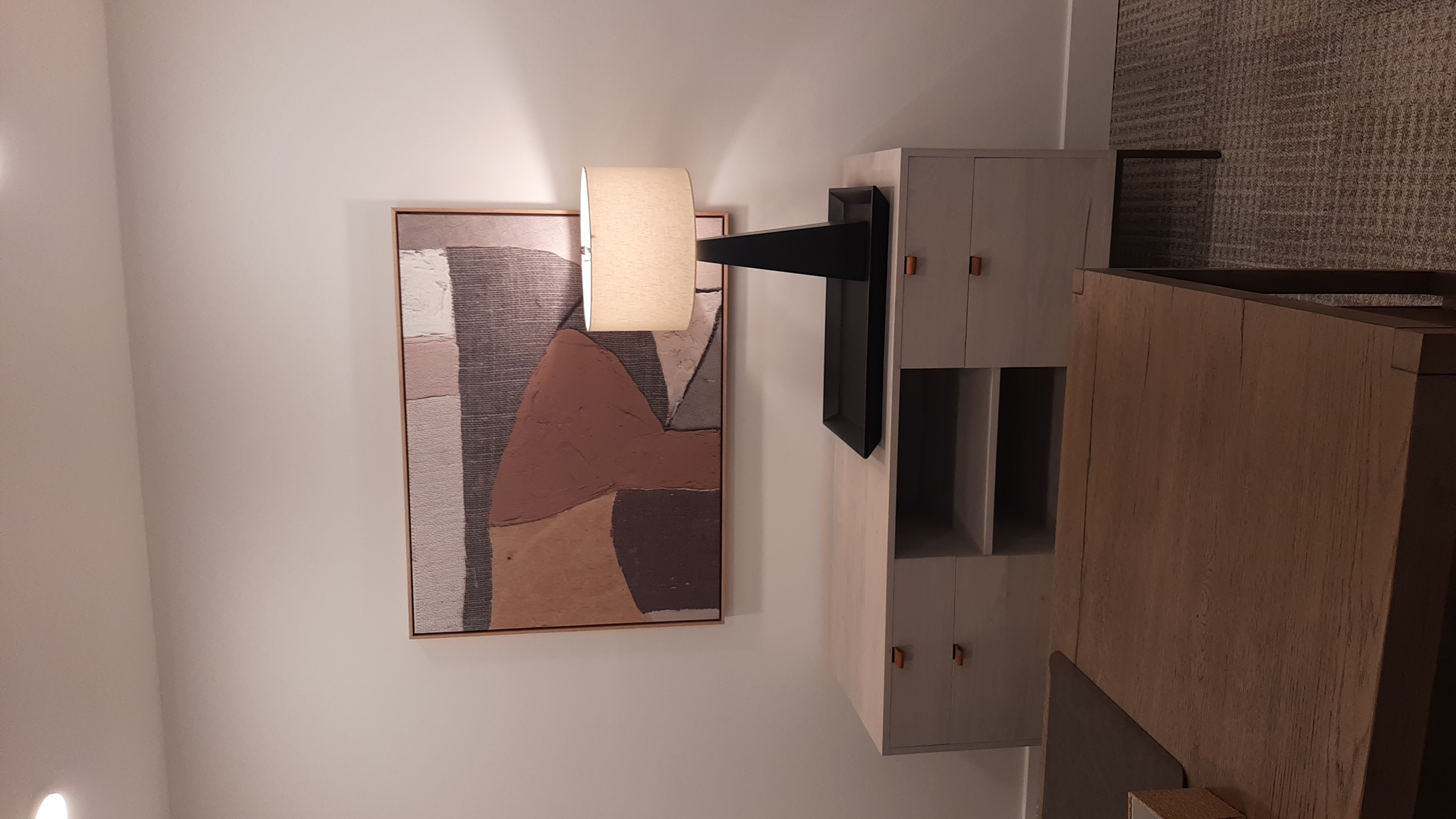 Office Abstract Art Mounting in Edmond, OK | Redhawk Handyman Large framed abstract art mounted above a credenza and table lamp in an office at a new Edmond, OK apartment community