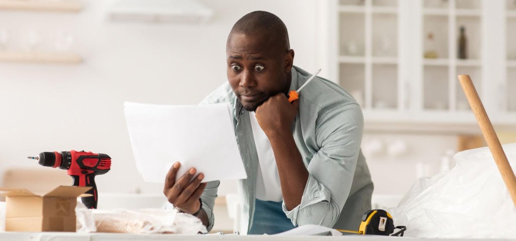 Frustrated customer surrounded by unassembled fitness equipment parts