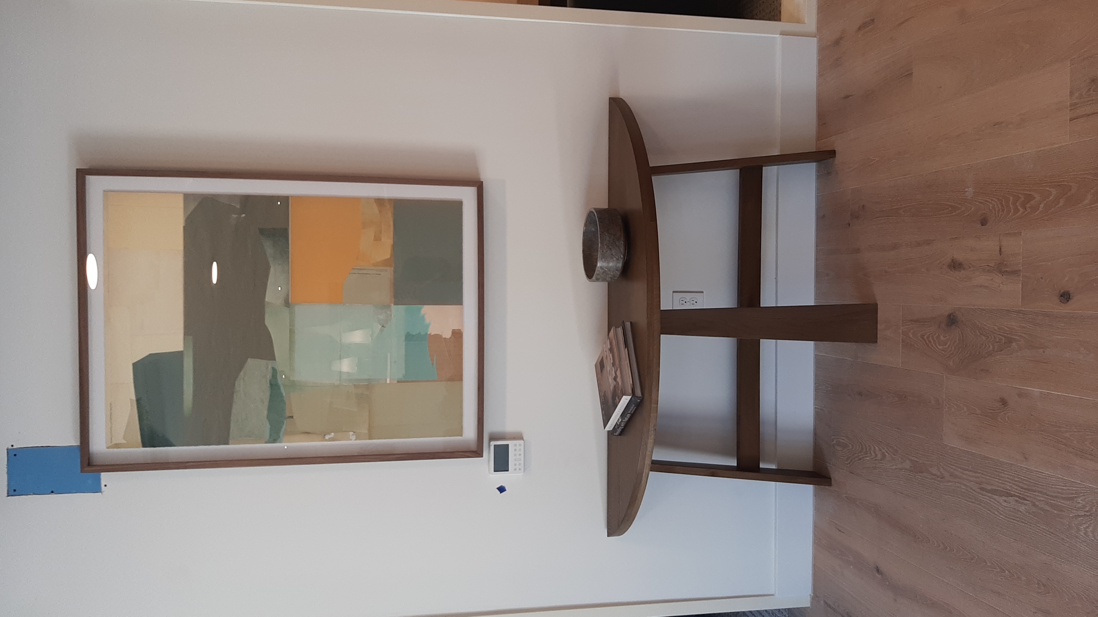 Entry Console Art Installation in Edmond, OK | Redhawk Handyman Oversized framed abstract art centered above a half-moon console table in the entryway of a new Edmond, OK apartment community